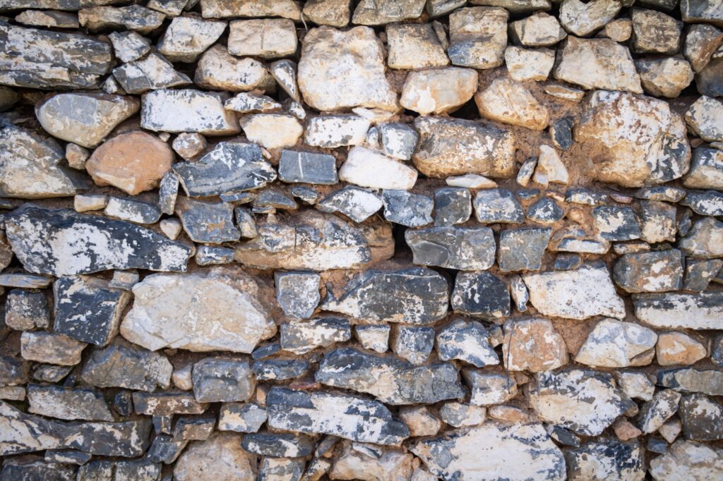 Natural stone wall for backdrop texture, white grey beige color, wallpaper.
